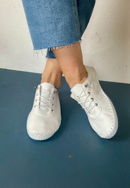 white flat pumps